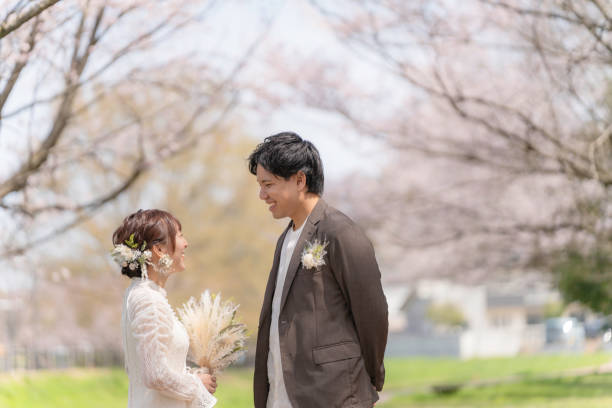 istock Casual wedding on a spring day when cherry blossoms bloom 2147680300