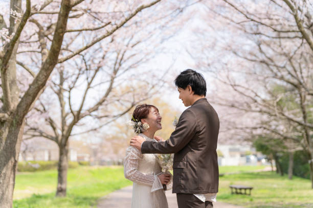 istock Casual wedding on a spring day when cherry blossoms bloom 2147680306
