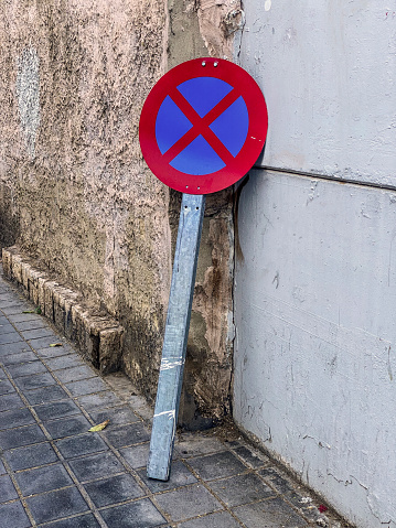 High angle view of a forbidden parking sign lying on a wall in the city of Valencia, Spain