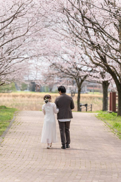 istock Casual wedding on a spring day when cherry blossoms bloom 2147680317