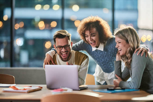istock Cheerful creative team working on laptop in the office. 2147680874