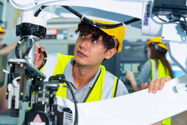 istock Male engineer working with robotic machine in factory. 2147681797