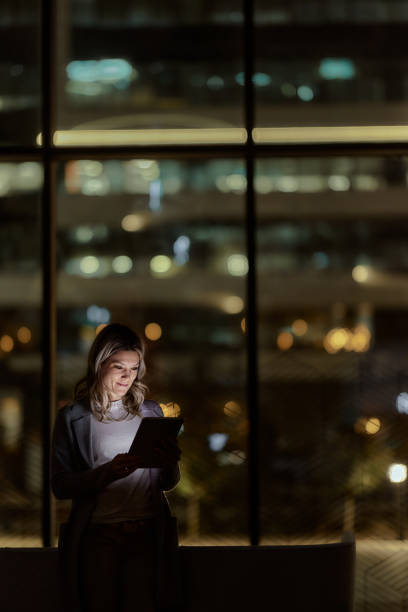 istock Young businesswoman using touchpad late in the office. 2147681808