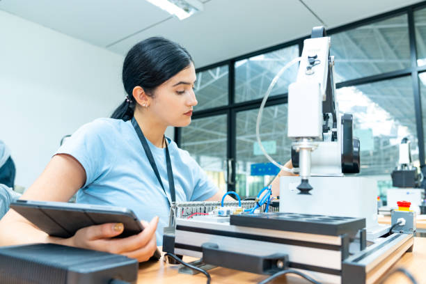 istock Female engineer working with robotic machine in factory. 2147681930