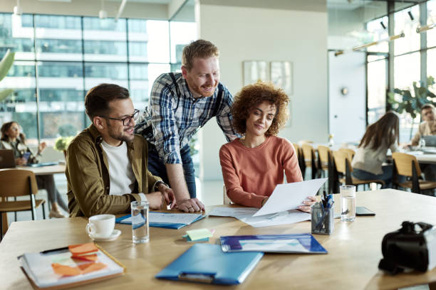 istock Happy millennial freelancers working on reports in a modern office. 2147681944