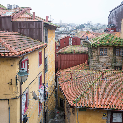 Details of the rooftops and the walls of the buildings in the Ribeira district of Porto, in Portugal. The area of the city is very old and the buildings are built very close to each other