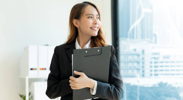 istock Business woman holding files Inside the modern office. 2147682793