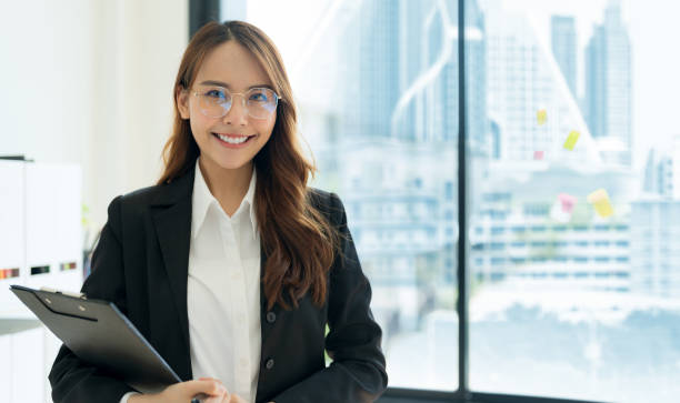 istock Business woman holding files Inside the modern office. 2147682796