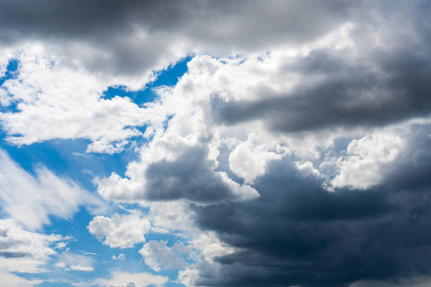 White dramatic cumulus clouds in the blue sky. Cloudy sky nature background. Overcast weather.