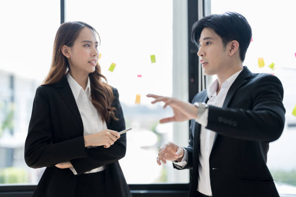 istock Business people discussing with each other From the note paper 2147683465