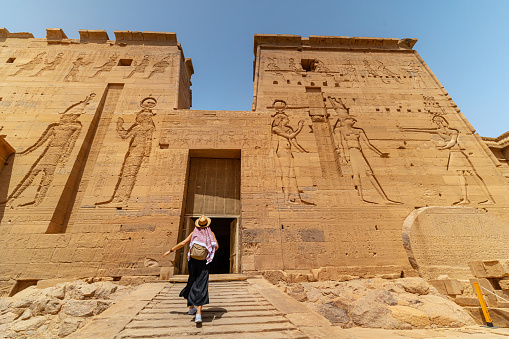 Woman walking in Temple of Philae aka Temple of Isis in Aswan Egypt