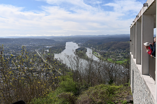 Remagen, Germany, March 31, 2024 - Tourists enjoy the view of the Rhine Valley with the island of Nonnenwerth and the Rhine river seen from Drachenfels.
