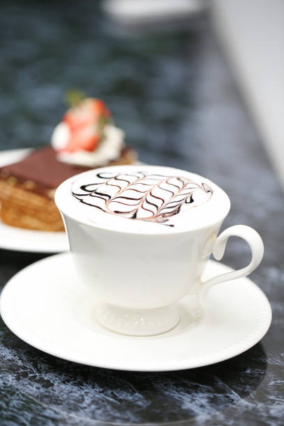 A cup of coffee with steam rising, placed on top of a saucer.