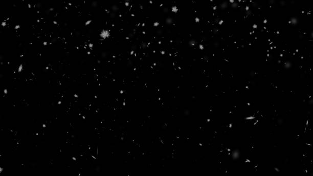 White snowflakes on a black background seamlessly looped. Snowfall, blizzard, realistic snow falls chaotically from top to bottom. Empty clean background. Abstract festive gradient New Year, Christmas background. 8k wallpaper 4k screensaver. Resolution 2K