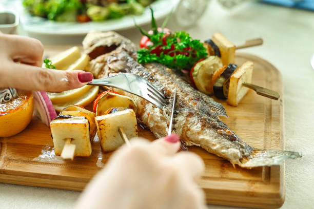 istock Person Cutting Up Vegetables on a Wooden Cutting Board 2147685070
