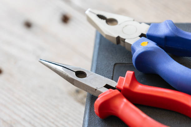 Needle nose pliers, professional tools for metal construction. Mechanic instrument for repairing works, close-up