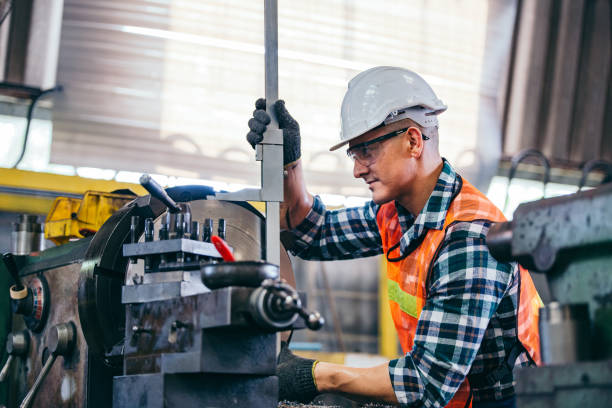 istock Male engineer metalworker industrial experienced operator technician worker in safety hard helmet working on lathe machine, professional man in industry technology manufacturing factory workshop 2147686234