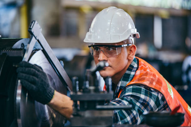 istock Male engineer metalworker industrial experienced operator technician worker in safety hard helmet working on lathe machine, professional man in industry technology manufacturing factory workshop 2147686245