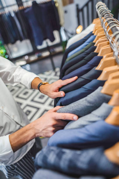 istock Male customer looking for the best suit in the store 2147686516