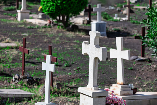 Stone crosses dotting the landscape of the cemetery create a reverent atmosphere