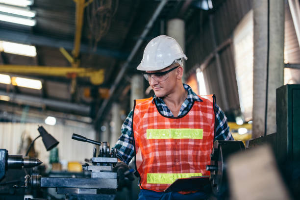 istock Engineer foreman factory with repair checklist document checking on industry machine at construction site. copy space 2147686834