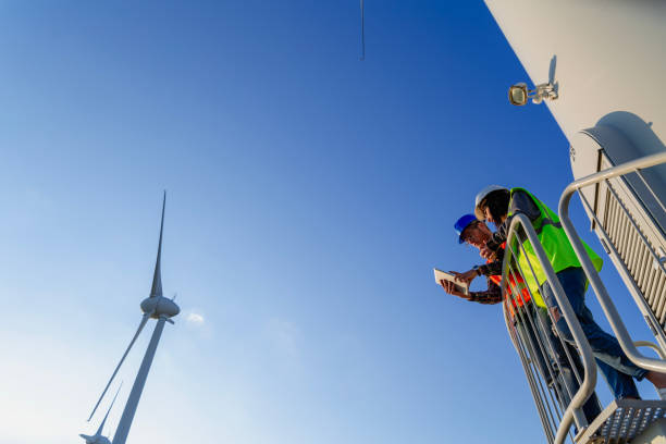 istock Engineers working on wind turbine in wind farm 2147686864