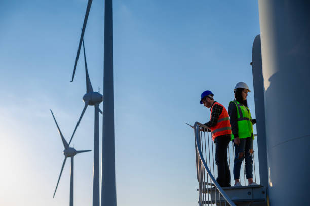 istock Engineers working on wind turbine in wind farm 2147686892