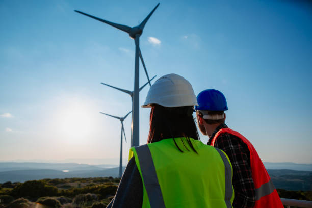 istock Engineers working on wind turbine in wind farm 2147687439