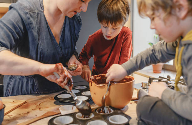 istock Young kids baking together with mom at home 2147687886