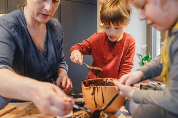 istock Young kids baking together with mom at home 2147687894