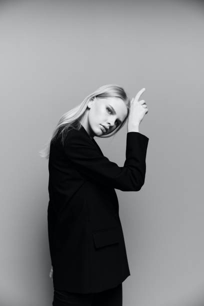 istock Charming young professional model puts her hand to her face cheek in the studio. The concept for the new collection. Classic black and white photo 2147688478