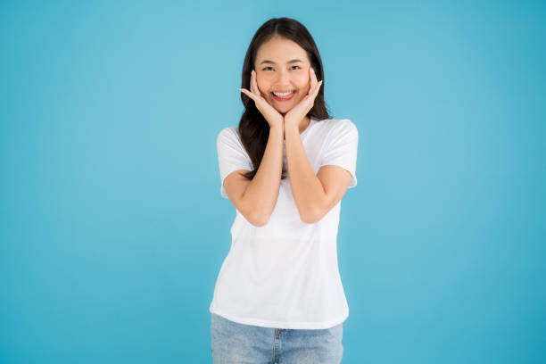 istock Beautiful Asian woman standing doing various poses on a blue background. 2147689340