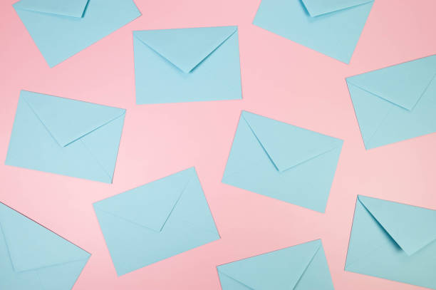 istock Top view of light blue envelopes on pink background. 2147690085