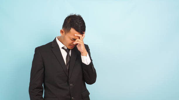 istock Stressed Asian businessman with hand on forehead 2147691367