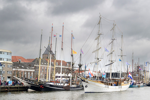 Traditional sailing ships in a canal in Groningen, Holland, during winter event 'Winterwelvaart'.