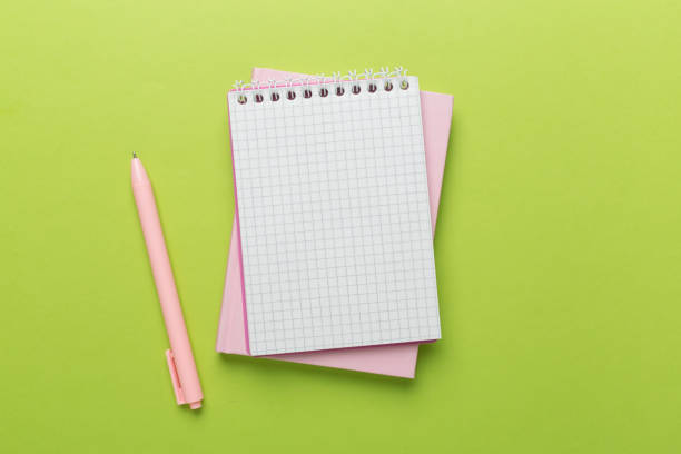istock Notebook with stationery on color background, top view 2147692697