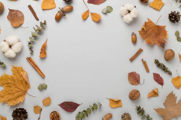 istock Autumn leaves with decor on wooden background, top view 2147692701