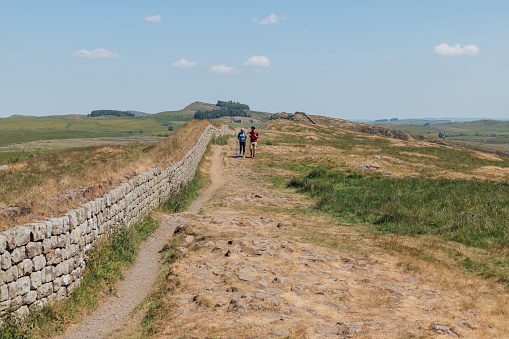 Hilly landscape in the Peak District in the UK with a stone fence