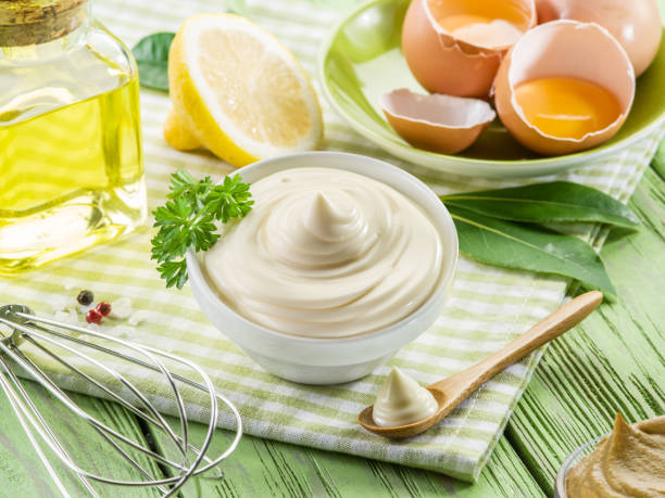 istock Homemade mayonnaise with ingredients and herbs. 2147693707