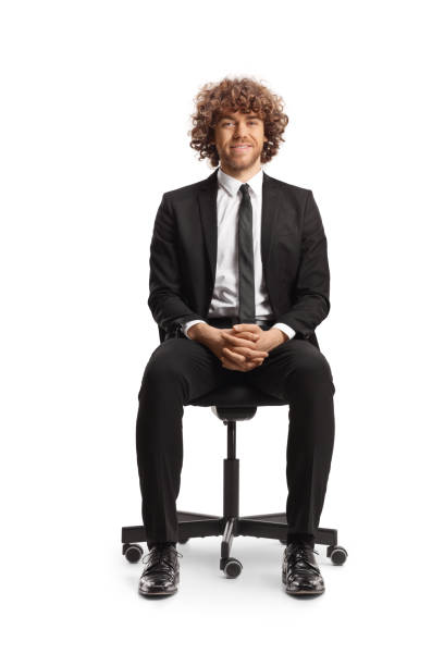 istock Young professional man sitting in an office chair and smiling 2147693866
