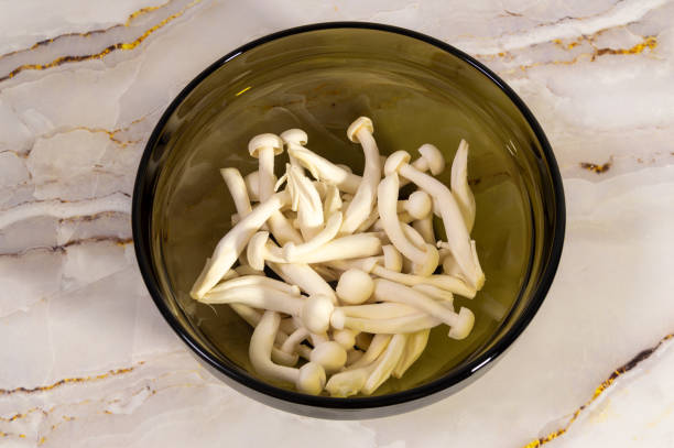 istock Shimeji mushrooms in the bowl on marble counter 2147694057