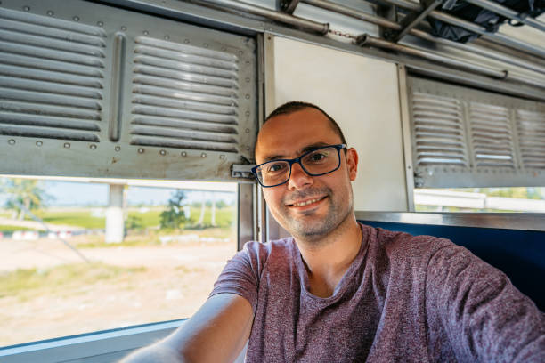 istock Young Man Taking Selfies On The Train In Thailand 2147694058
