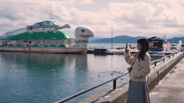 Tourist women take photo at Inawashiro lake
