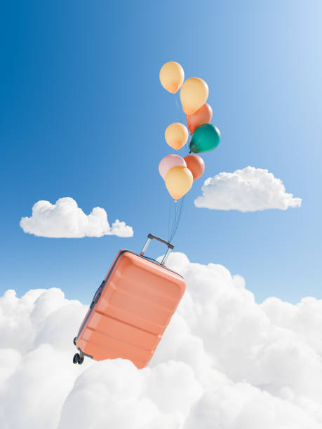 istock Floating Suitcase with Colorful Balloons in Sky among Clouds 2147696649