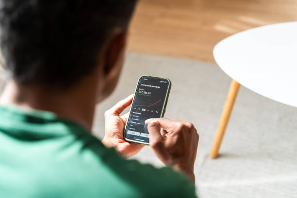 istock Man checking stock market on smartphone 2147697765