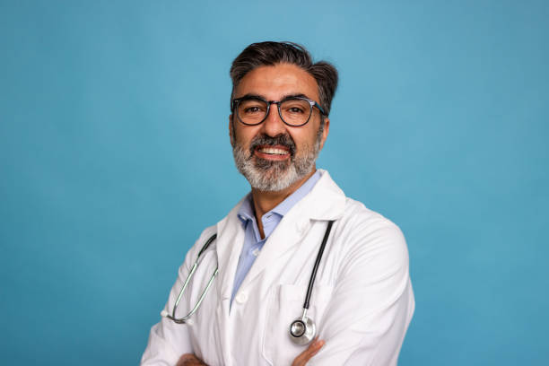 istock Smiling doctor with stethoscope on blue background 2147697889