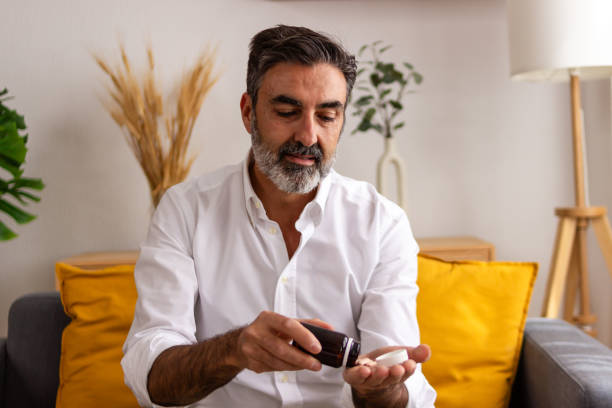 istock Middle-aged man relaxing at home with smartphone 2147698133