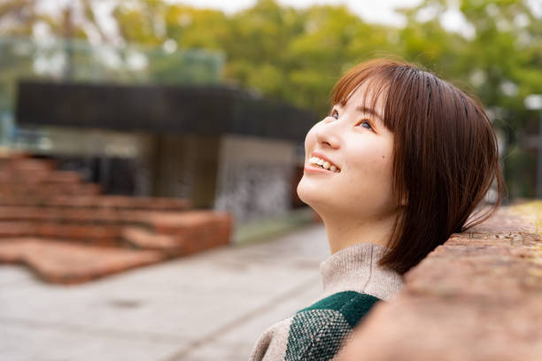 istock Woman playing in a park with a brick wall 2147698754