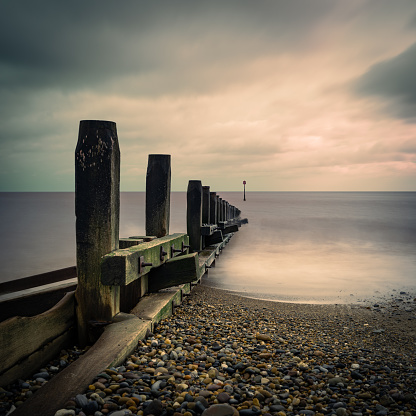 A long exposure image of  Hornsea Beach on the North Sea Coast in the  East Riding of Yorkshire, England. The timber Groynes shown are designed to slow erosion.