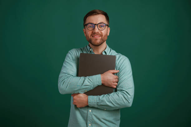 istock Silver colored laptop in hands. Man is standing against background in the studio 2147701441
